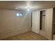 Finished basement with a closet, storage bench, and tiled floors at 1120 Dayton St, Aurora, CO 80010