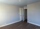 Bright bedroom with neutral paint, wood floors, and large windows for natural light at 1120 Dayton St, Aurora, CO 80010