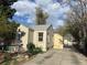 Home exterior shows driveway and backyard with trees, landscaping and sunshine at 1120 Dayton St, Aurora, CO 80010