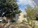 Quaint home with small porch, landscaping and stairs leading to the front door at 1120 Dayton St, Aurora, CO 80010