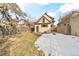 Backyard featuring grass, snow, wooden fence, and a tan-colored house exterior at 377 S Grant St, Denver, CO 80209