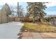 Spacious backyard featuring a wooden fence and grass area, partially covered in snow at 377 S Grant St, Denver, CO 80209