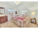 Charming bedroom with a brass bed frame, vintage dresser, and a window with detailed trim at 377 S Grant St, Denver, CO 80209