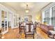 Dining room featuring hardwood floors, large windows, and a classic dining table with seating for six at 377 S Grant St, Denver, CO 80209