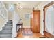 Bright entryway with hardwood floors, decorative windows, and a classic staircase with detailed woodwork at 377 S Grant St, Denver, CO 80209