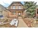 Charming brick home featuring a covered front porch, landscaped yard, and a classic architectural design at 377 S Grant St, Denver, CO 80209