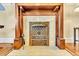 Close up on the fireplace featuring an ornate metal grill, white tiled hearth, and classic wooden frame at 377 S Grant St, Denver, CO 80209