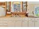 Bright kitchen with wood countertops, brick backsplash, and vintage glass front cabinets at 377 S Grant St, Denver, CO 80209