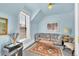 Cozy living room featuring a comfortable couch, area rug, and bright blue walls at 377 S Grant St, Denver, CO 80209