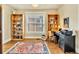 Bright home office featuring hardwood floors, built-in bookshelves, a desk, and a large window at 377 S Grant St, Denver, CO 80209