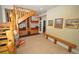Spacious basement area with a unique wooden staircase, custom bunk beds, and tiled flooring at 9716 Canon Dr, Sedalia, CO 80135