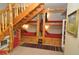 Custom built-in bunk beds with wooden accents and a playful design in the finished basement at 9716 Canon Dr, Sedalia, CO 80135