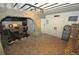 Basement area with stone archway leading to a wine cellar, featuring brick floors and a rustic design at 9716 Canon Dr, Sedalia, CO 80135