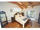 Bedroom features wood floors, a queen-size bed, and sliding glass doors leading to an outdoor balcony at 9716 Canon Dr, Sedalia, CO 80135