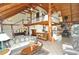 Open-concept living room with vaulted ceilings, wood beams, a cozy seating area, and seamless access to the kitchen at 9716 Canon Dr, Sedalia, CO 80135