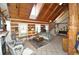 Cozy living room featuring wood-paneled walls, a staircase, comfortable seating, and ample natural light at 9716 Canon Dr, Sedalia, CO 80135