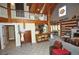Spacious living room with vaulted wood beam ceilings, open floor plan, and cozy fireplace at 9716 Canon Dr, Sedalia, CO 80135