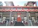 Inviting front porch decorated with patriotic bunting, rocking chairs, and a charming red front door at 9716 Canon Dr, Sedalia, CO 80135