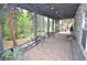 Spacious brick porch overlooking wooded acreage, with comfortable seating arrangements for relaxing and entertaining at 9716 Canon Dr, Sedalia, CO 80135