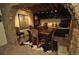 Cozy wine cellar with stone accents, custom shelving, and a table for tasting, creating a rustic retreat at 9716 Canon Dr, Sedalia, CO 80135
