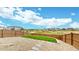 Gravel backyard with green space, stone walkways, and a wood fence at 3625 Silver Rock Cir, Castle Rock, CO 80104