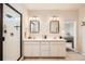 Stylish bathroom features a double vanity, walk-in shower with glass door, and modern fixtures at 3625 Silver Rock Cir, Castle Rock, CO 80104
