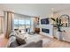 Bright living room boasts a modern fireplace, hardwood floors, and sliding glass doors to the backyard at 3625 Silver Rock Cir, Castle Rock, CO 80104