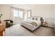 Bright main bedroom featuring a large window, neutral tones, and comfortable seating area at 3625 Silver Rock Cir, Castle Rock, CO 80104