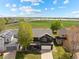 Aerial view of a two-story home in a neighborhood with a large grass field in the background at 5249 Mt Arapaho Cir, Frederick, CO 80504