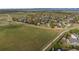 An aerial shot showcases a neighborhood's homes adjacent to a grassy field and walking trails at 5249 Mt Arapaho Cir, Frederick, CO 80504