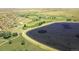 Aerial showing community with lake, golf course, and residential neighborhood at 5249 Mt Arapaho Cir, Frederick, CO 80504