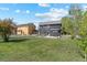 Large fenced backyard with patio area and ample green space between neighboring homes at 5249 Mt Arapaho Cir, Frederick, CO 80504