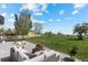 A spacious backyard with lush green grass extends beyond a concrete patio with comfortable seating at 5249 Mt Arapaho Cir, Frederick, CO 80504