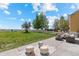 A well-maintained backyard with outdoor seating and a pristine, white picket fence is shown at 5249 Mt Arapaho Cir, Frederick, CO 80504