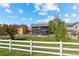 Spacious backyard featuring green lawn, patio area, and charming white picket fence at 5249 Mt Arapaho Cir, Frederick, CO 80504