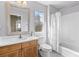 Bathroom with wood vanity, framed mirror and shower and tub combination at 5249 Mt Arapaho Cir, Frederick, CO 80504