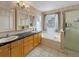 Bathroom featuring double sinks, soaking tub, and walk-in shower at 5249 Mt Arapaho Cir, Frederick, CO 80504