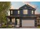 Charming two-story home with a covered front porch featuring hanging flower baskets and an attached garage at 5249 Mt Arapaho Cir, Frederick, CO 80504