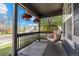 Inviting front porch with stylish egg chair, outdoor rug, and hanging flower baskets create a cozy space at 5249 Mt Arapaho Cir, Frederick, CO 80504