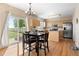 Eat-in kitchen with stainless steel appliances, center island, and access to the backyard at 5249 Mt Arapaho Cir, Frederick, CO 80504