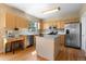 Spacious kitchen featuring stainless steel appliances, a center island, and bright lighting at 5249 Mt Arapaho Cir, Frederick, CO 80504