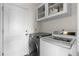 Laundry room with washer, dryer, and overhead cabinet storage at 5249 Mt Arapaho Cir, Frederick, CO 80504