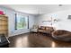 Cozy living room with a window, a sofa, a chair, a bookshelf, and a colorful lamp at 5249 Mt Arapaho Cir, Frederick, CO 80504