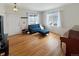 Bright living room featuring hardwood floors, white walls, and ample natural light from two windows at 5249 Mt Arapaho Cir, Frederick, CO 80504