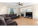 Cozy living room with hardwood floors, ceiling fan, and fireplace at 5249 Mt Arapaho Cir, Frederick, CO 80504