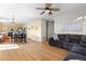 Open floor plan with hardwood floors seamlessly connecting living room and dining area at 5249 Mt Arapaho Cir, Frederick, CO 80504