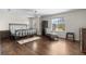 Spacious main bedroom with hardwood floors, a chaise lounge, and natural lighting at 5249 Mt Arapaho Cir, Frederick, CO 80504