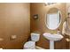 Powder room featuring a pedestal sink, toilet, and wallpaper at 5249 Mt Arapaho Cir, Frederick, CO 80504