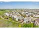 Wide aerial shot of the home in a suburban neighborhood, highlighting its location and backyard at 6990 E 132Nd Pl, Thornton, CO 80602