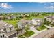 Aerial view of home and well-maintained lawn in a quiet neighborhood with green space at 6990 E 132Nd Pl, Thornton, CO 80602